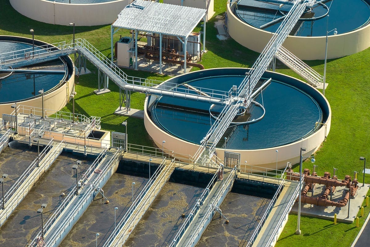 Aerial view of a municipal water treatment plant with clarifiers and treatment basins
