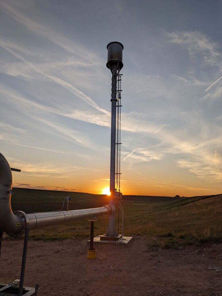 A sunset behind industrial filtration equipment